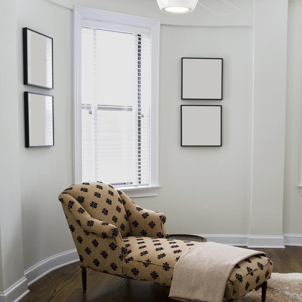 Antique chaise lounge in white interior.